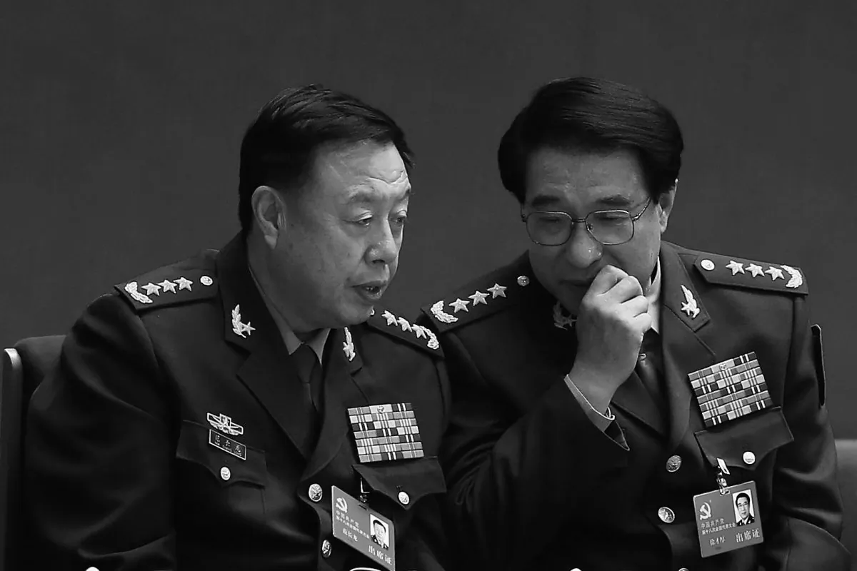 Chinese vice chairmen of the Central Military Commission Xu Caihou (R) and Fan Changlong talk during the closing session of the 18th National Congress of the Communist Party of China at the Great Hall of the People on Nov. 14, 2012 in Beijing, China. Xu, under investigation for bribery, died from cancer on March 16, according to state news media. (Lintao Zhang/Getty Images)