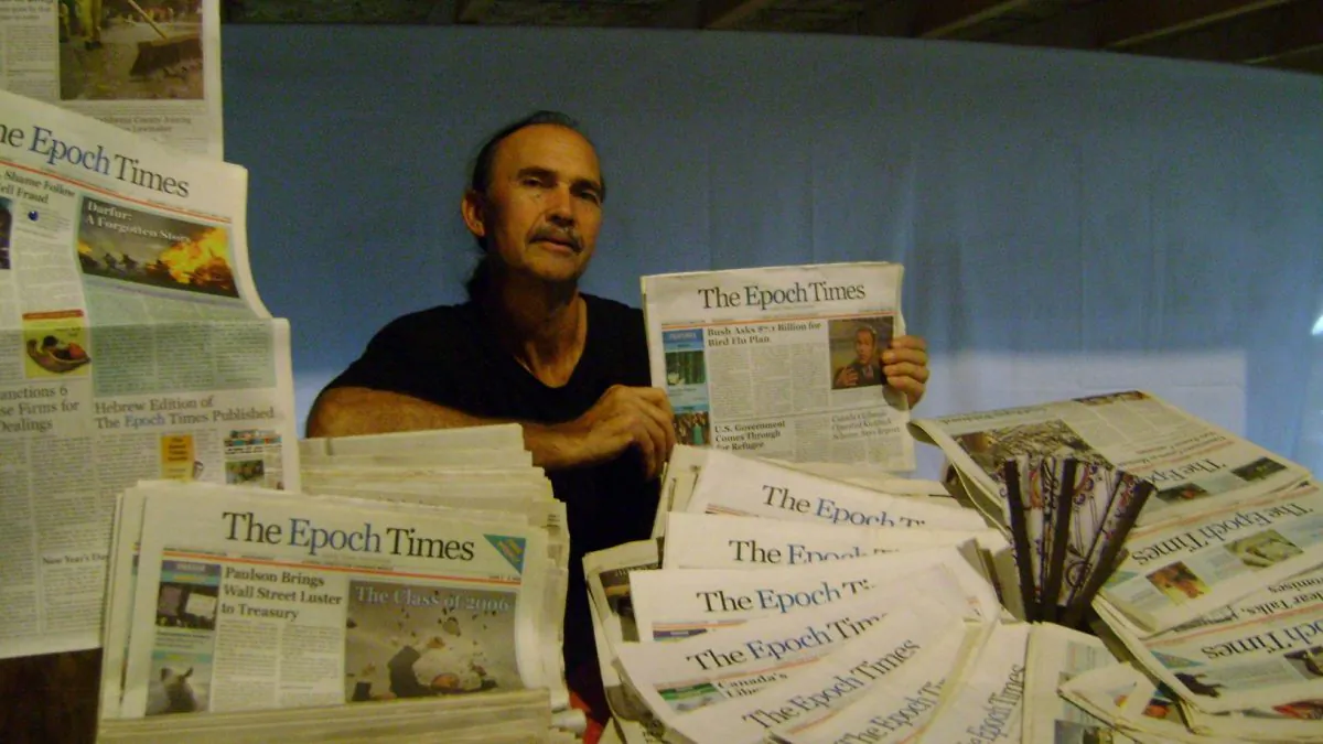 Steven Hersom shows his collection of past issues of the Epoch Times. After reading the Epoch Times, Mr. Hersom was moved to start distributing the paper on his own so that more people could read it. (Sophia Fang/Epoch Times)