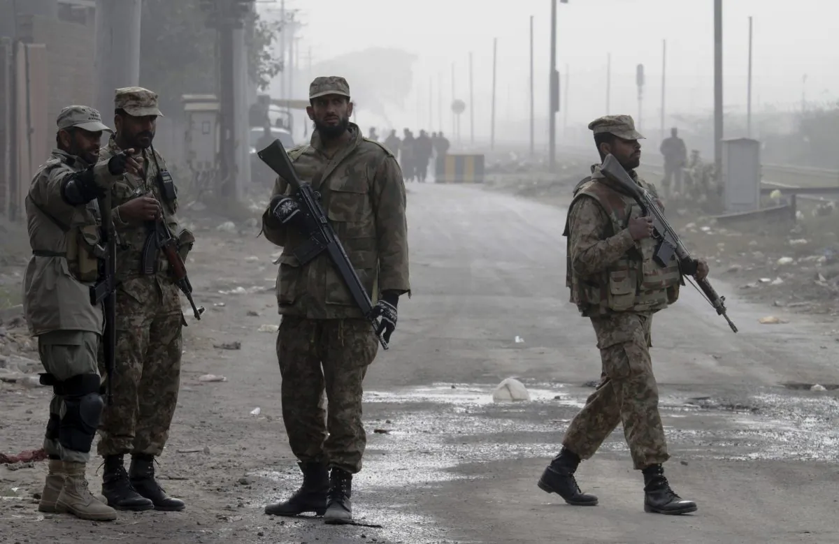 Pakistan army troops stand guard at a road on Dec. 20, 2014. (K.M. Chaudary/Photo via AP)