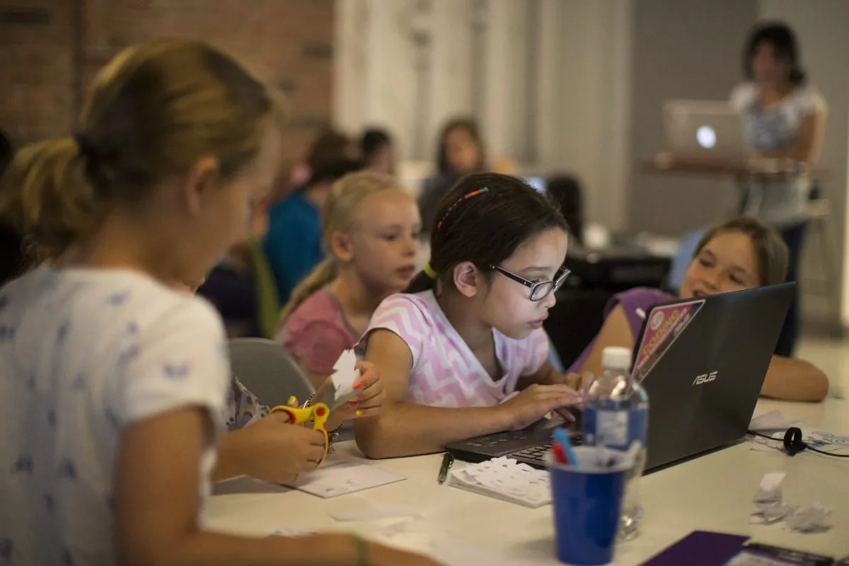 Girls learn about computers at an early age by attending a workshop in Toronto on July 16, 2014. The need to fill the skilled jobs required in the information and communications technology field means that it is important to encourage a greater percentage of young women to get involved. (The Canadian Press/Chris Young)