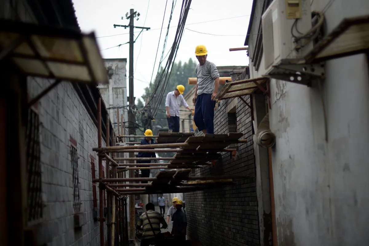 A group of Chinese workers build a house in an alley in Beijing on May 24, 2014. (Wang Zhao/AFP/Getty Images)