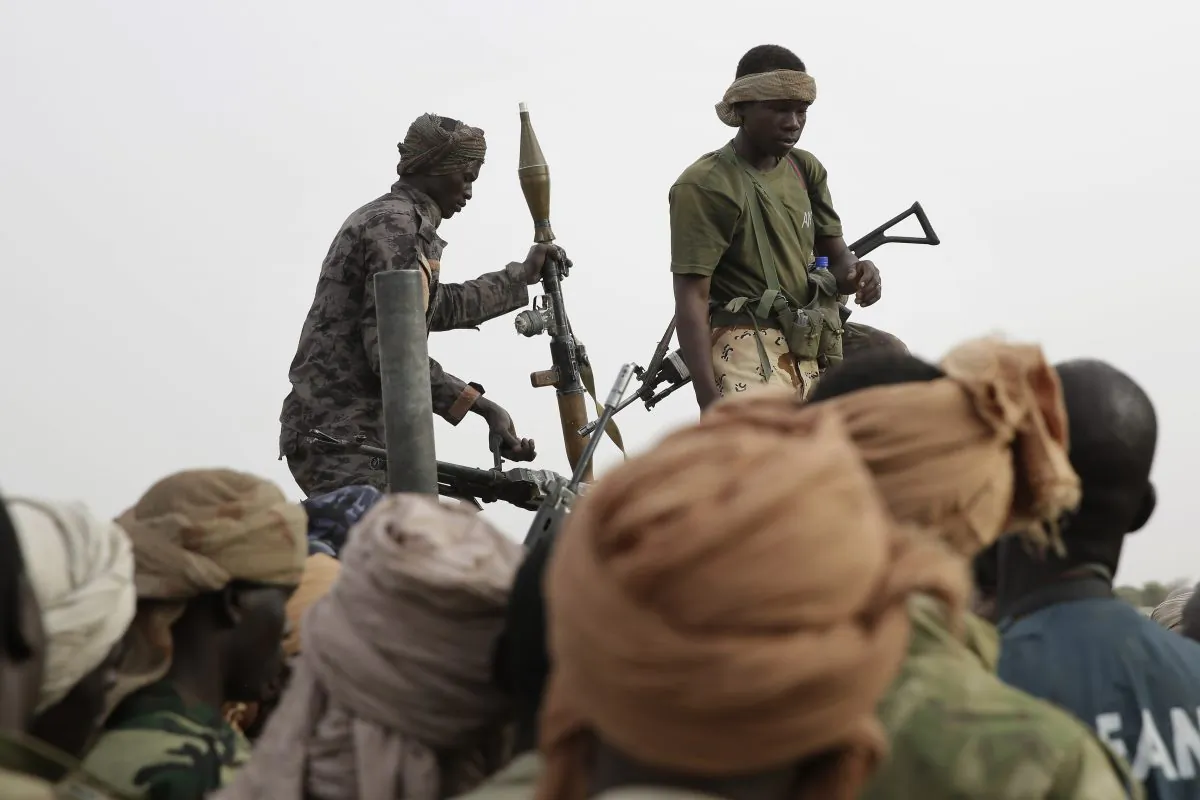 Chadian soldiers transfer weapons seized from Boko Haram fighters to a truck in the Nigerian city of Damasak, Nigeria, Wednesday March 18, 2015. Damasak was flushed of Boko Haram militants last week, and is now controlled by a joint Chadian and Nigerien force. (AP Photo/Jerome Delay)