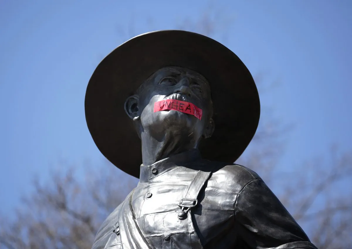Tape with the word "UNHEARD" covers the mouth of the sculpture "The Sower" at the University of Oklahoma in Norman, Okla., on March 11, 2015. (Brett Deering/Getty Images)
