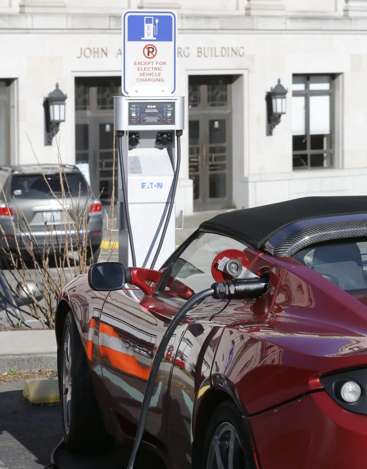 A Tesla electric car is plugged in while parked at a parking spot reserved for charging electric vehicles at the Capitol in Olympia, Wash., on Feb. 17, 2015. (Ted S. Warren/AP Photo)