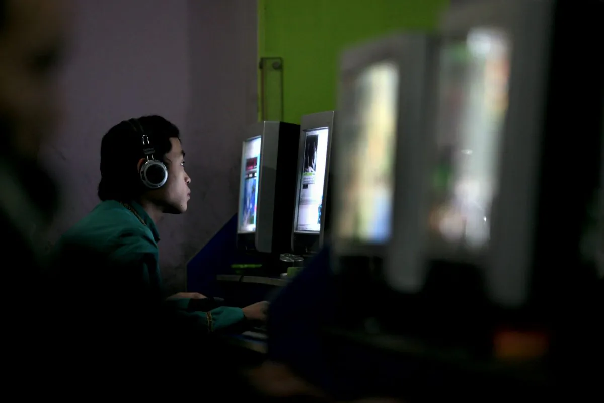 A Chinese youth plays online game in a net cafe on January 21, 2008 in Chongqing Municipality, China. (China Photos/Getty Images)