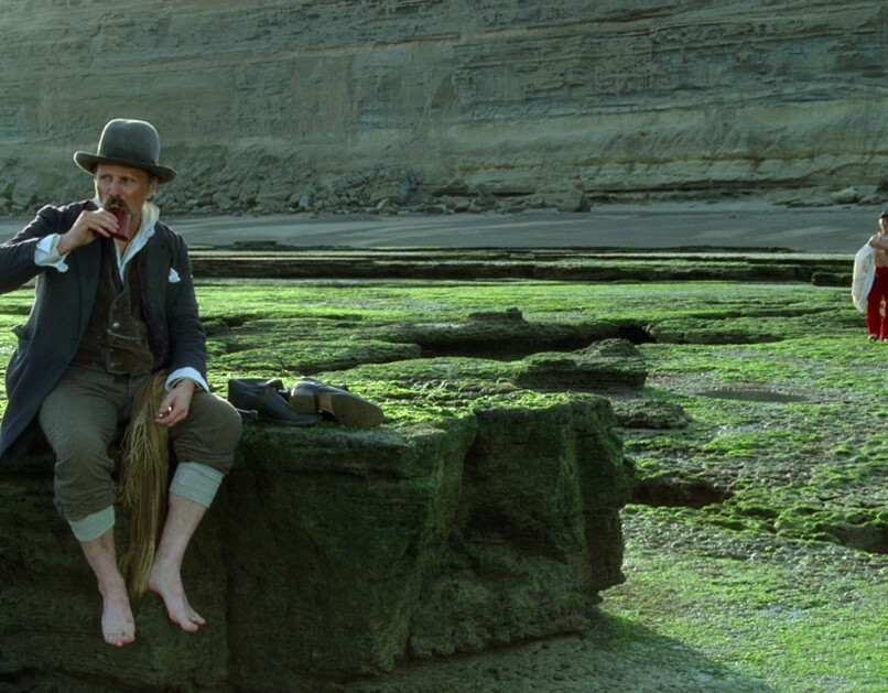 man drinking and looking at grass in "Jauja"