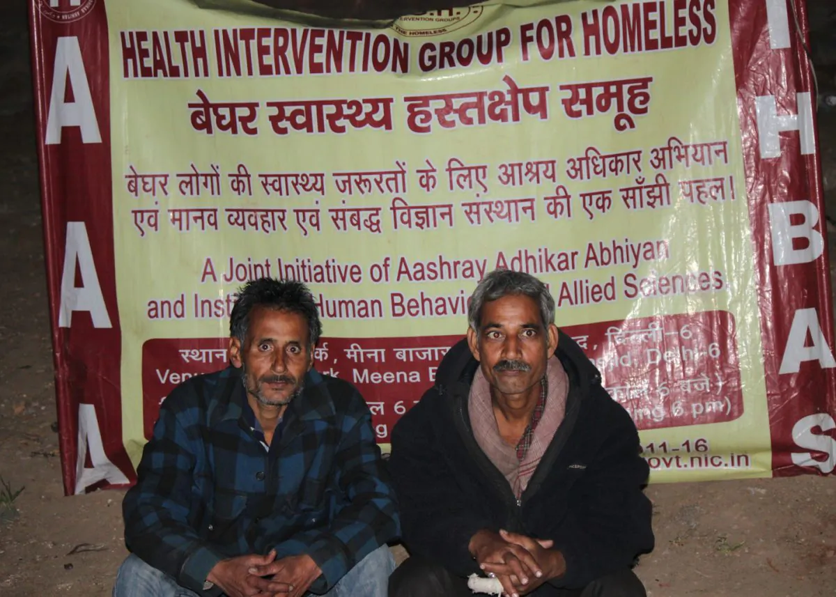 Two rickshaw pullers wait their turn to consult a doctor about drug addition treatments at a free street clinic in old Delhi on Feb. 9, 2015. (Venus Upadhayaya/Epoch Times)