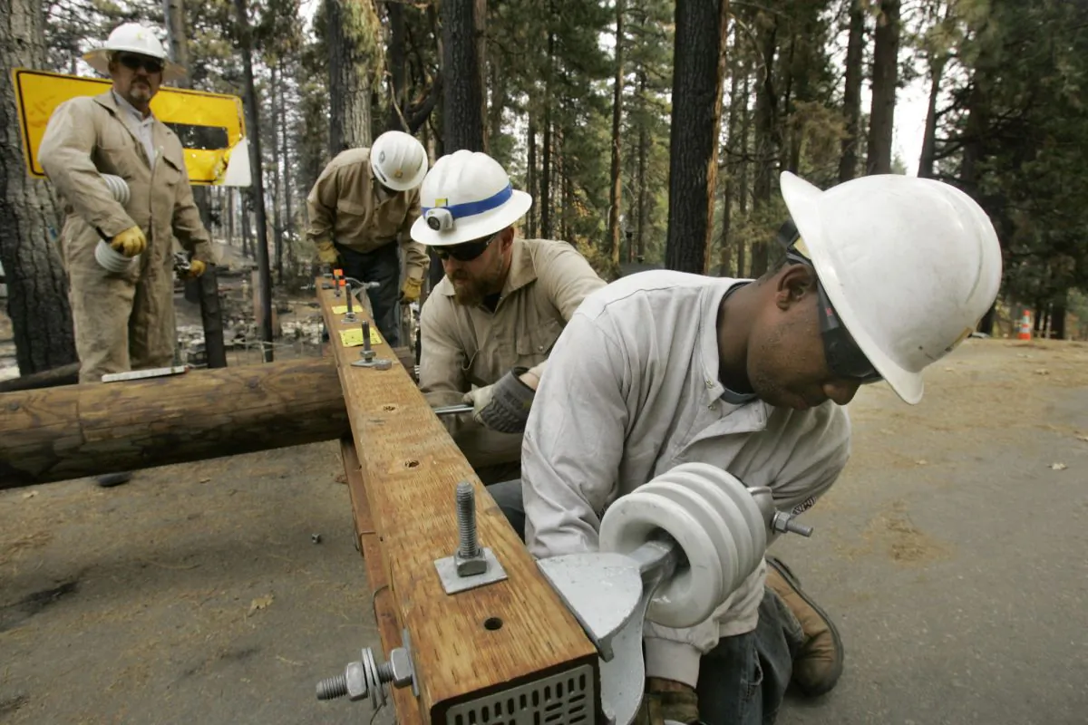 Southern California Edison power crews work to restore power a subdivision, which was decimated by Fire, in Running Springs, Calif., Saturday, Oct. 27, 2007.(AP Photo/Marcio Jose Sanchez)