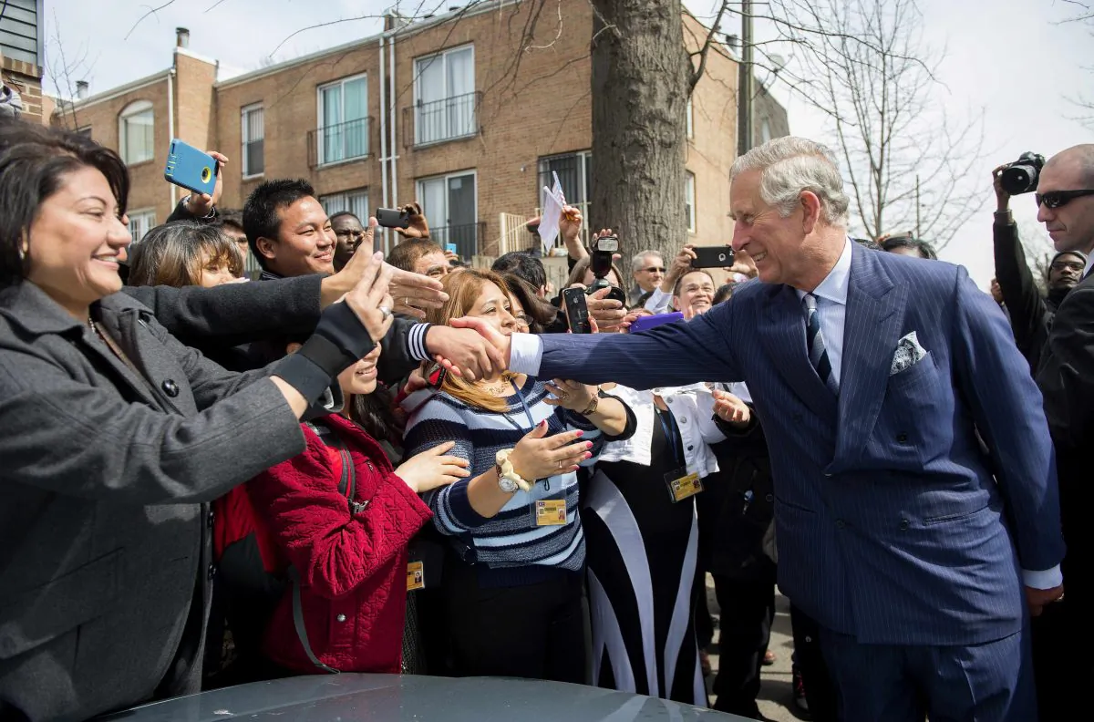 Britain's Prince Charles (R) shakes hands with a crowd outside the Carlos Rosario School in Washington on March 19, 2015. (Jim Watson/AFP/Getty Images)