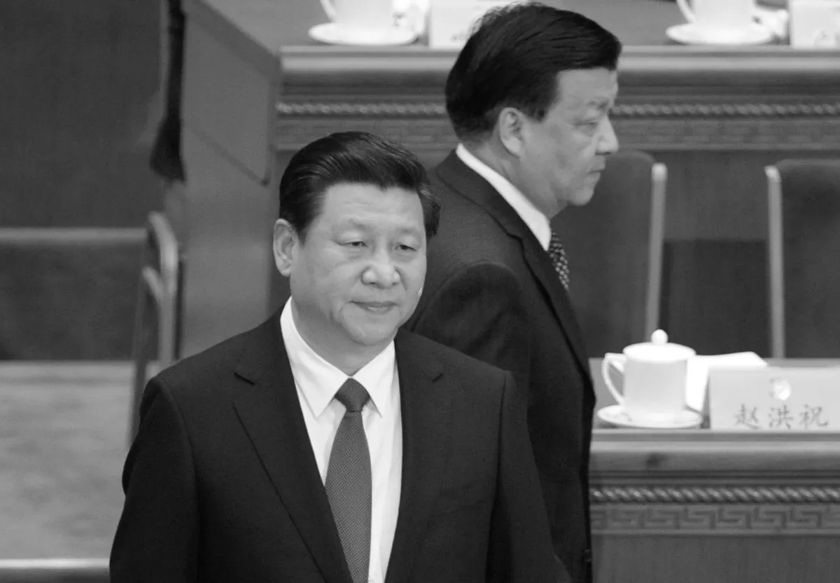 Liu Yunshan (top), walks past Chinese leader Xi Jinping at the Great Hall of the People on March 3, 2014. A Hong Kong media reveals the wealth of the seven most powerful officials in China. (Wang Zhao/AFP/Getty Images)