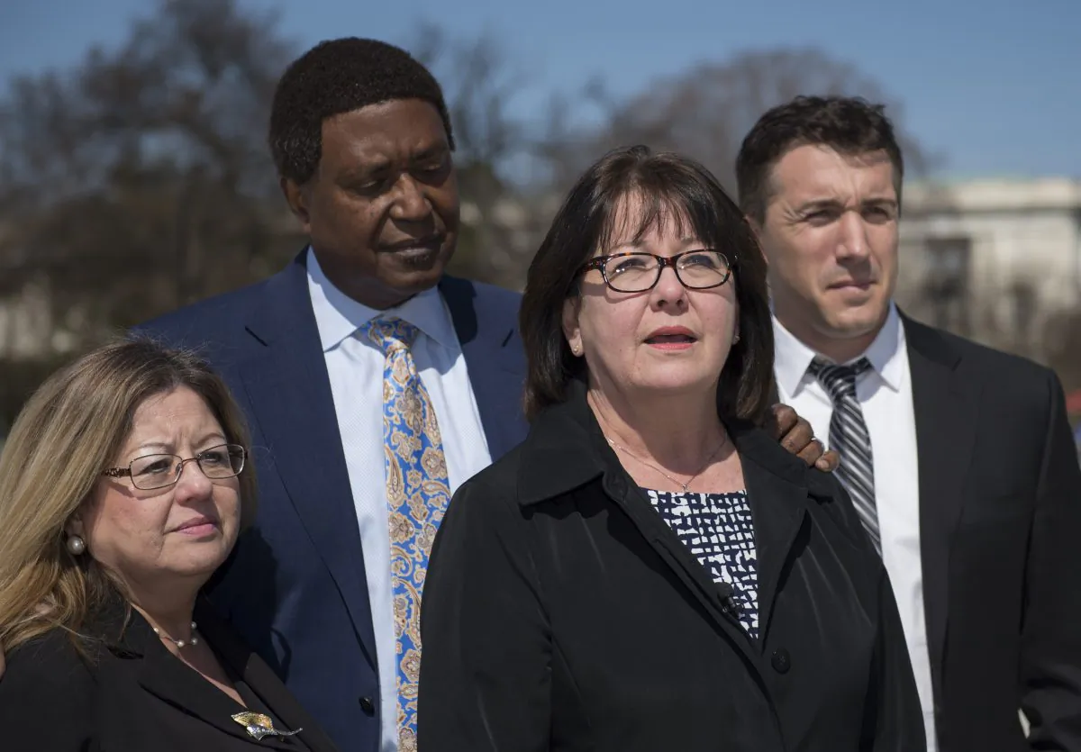 Frances Sheehan, sister of Teresa Sheehan, speaks to reporters outside the Supreme Court in Washington, D.C., Monday, March 23, 2015, with (L to R) her sister Joanne Sheehan, and attorneys John Burris and Ben Nisenbaum, after the Supreme Court heard arguments in the San Francisco v. Sheehan case. (AP Photo/Molly Riley)