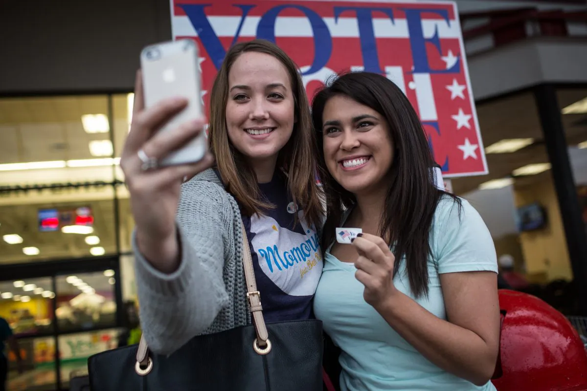 Lauren Koepp and Kara Smyth pose for a photo after casting their votes on Election Day early Tuesday morning, Nov. 4, 2014 in Austin, Texas. (AP Photo/Tamir Kalifa)