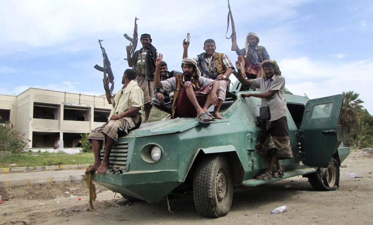  In this Friday, March 20, 2015 file photo, militiamen loyal to President Abed Rabbo Mansour Hadi ride on an army vehicle on a street in Aden, Yemen.(AP Photo/Yassir Hassan)