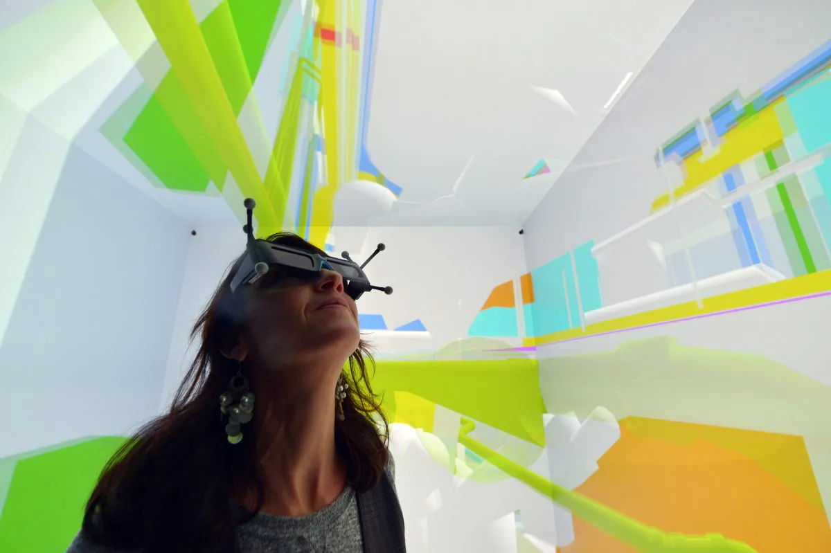 A woman wearing 3D glasses tests a Cave Automatic Virtual Environment (CAVE) virtual reality theatre during its presentation at the Industrial Centre for Virtual Reality in Saint-Nazaire on December 1, 2014. (Georges Gobet/AFP/Getty Images)