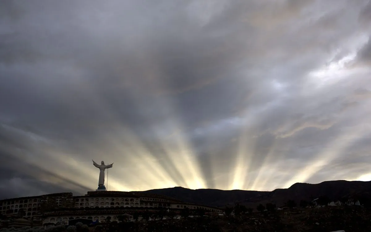The last rays of the sun are seen at dusk at a cemetery in Yungay, Peru, Tuesday, Dec. 2, 2014. (AP Photo/Rodrigo Abd)