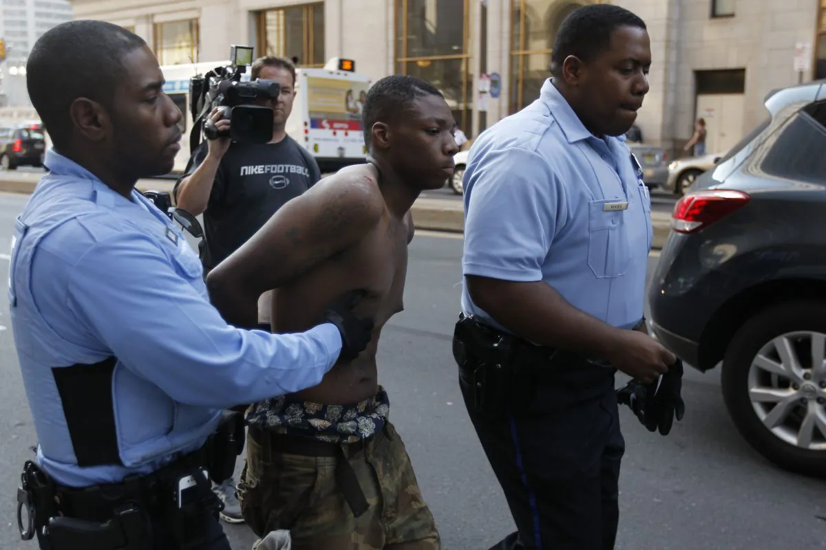 Philadelphia Police officers detain a suspect Thursday, March 22, 2012, in Philadelphia. (AP Photo/Matt Rourke)