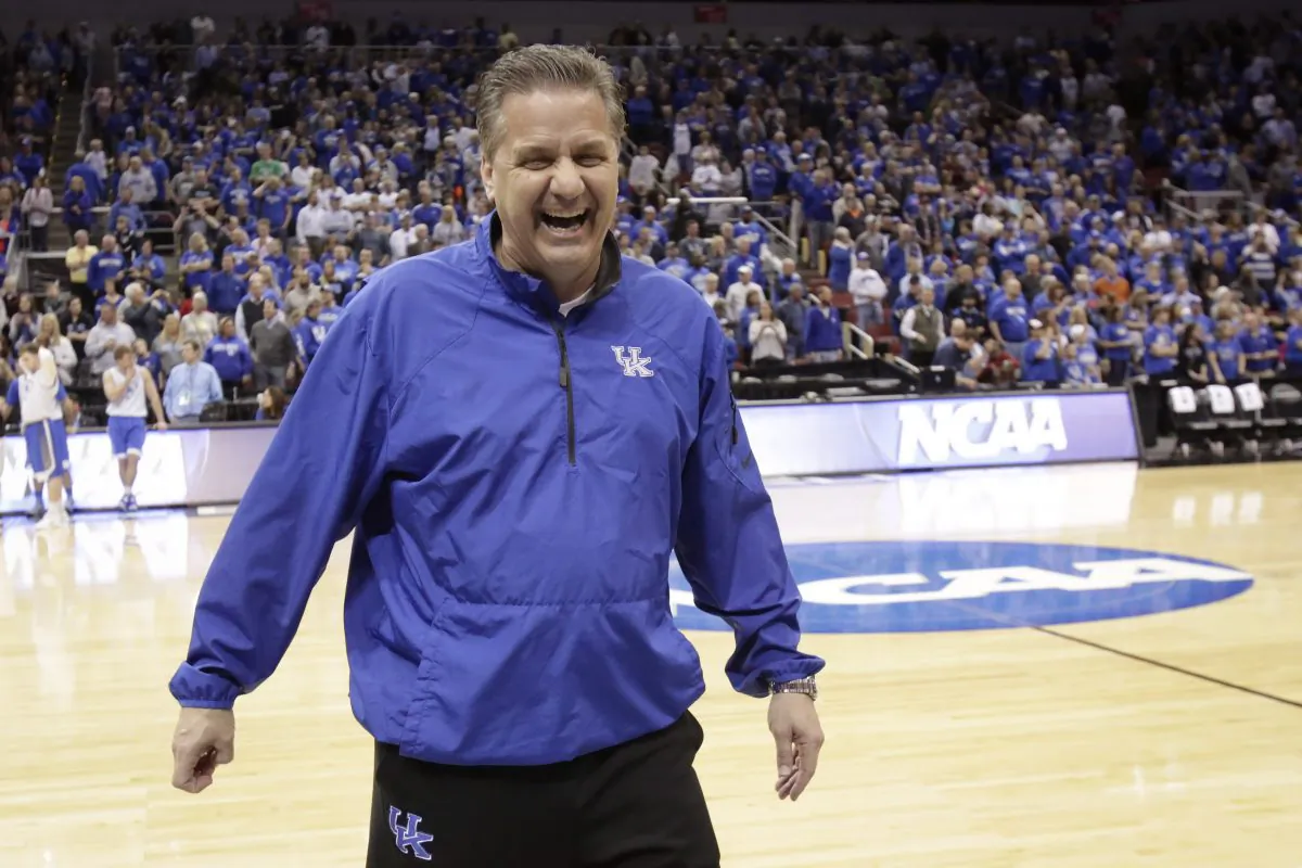 Kentucky head coach John Calipari jokes around with members of the media during practice for an NCAA college basketball second round game in Louisville, Ky., Wednesday, March 18, 2015. (AP Photo/David Stephenson)
