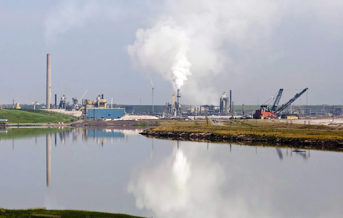 An oil sands facility tailings pond near Fort McMurray. In a letter to Alberta's pollution monitoring agency, the group responsible for air-quality testing says its mobile unit is off the road due to funding problems. (The Canadian Press/Jeff McIntosh)