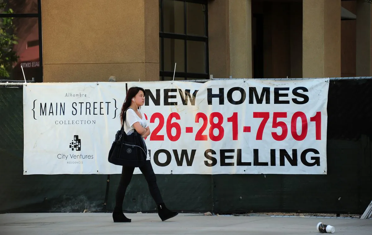 An advertising banner for new home sales in Alhambra, Calif., on Sept. 26, 2013. Currently the spread between the five-year CD rates and 15-year mortgages is only about 1.65 percent. (Frederic J. Brown/AFP/Getty Images)