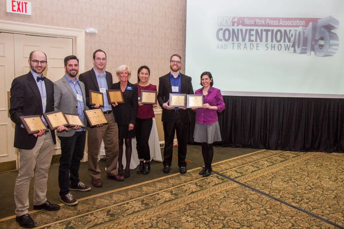 Michelle Rea, Executive Director of NYPPA (C) and staff members from the Epoch Times, hold eight first place awards and one John J. Evans award for Advertising Excellence, won at the 2015 New York Press Association and Trade show in Saratoga Springs, N.Y., on March 28, 2015. (Jan Jekielek/Epoch Times)