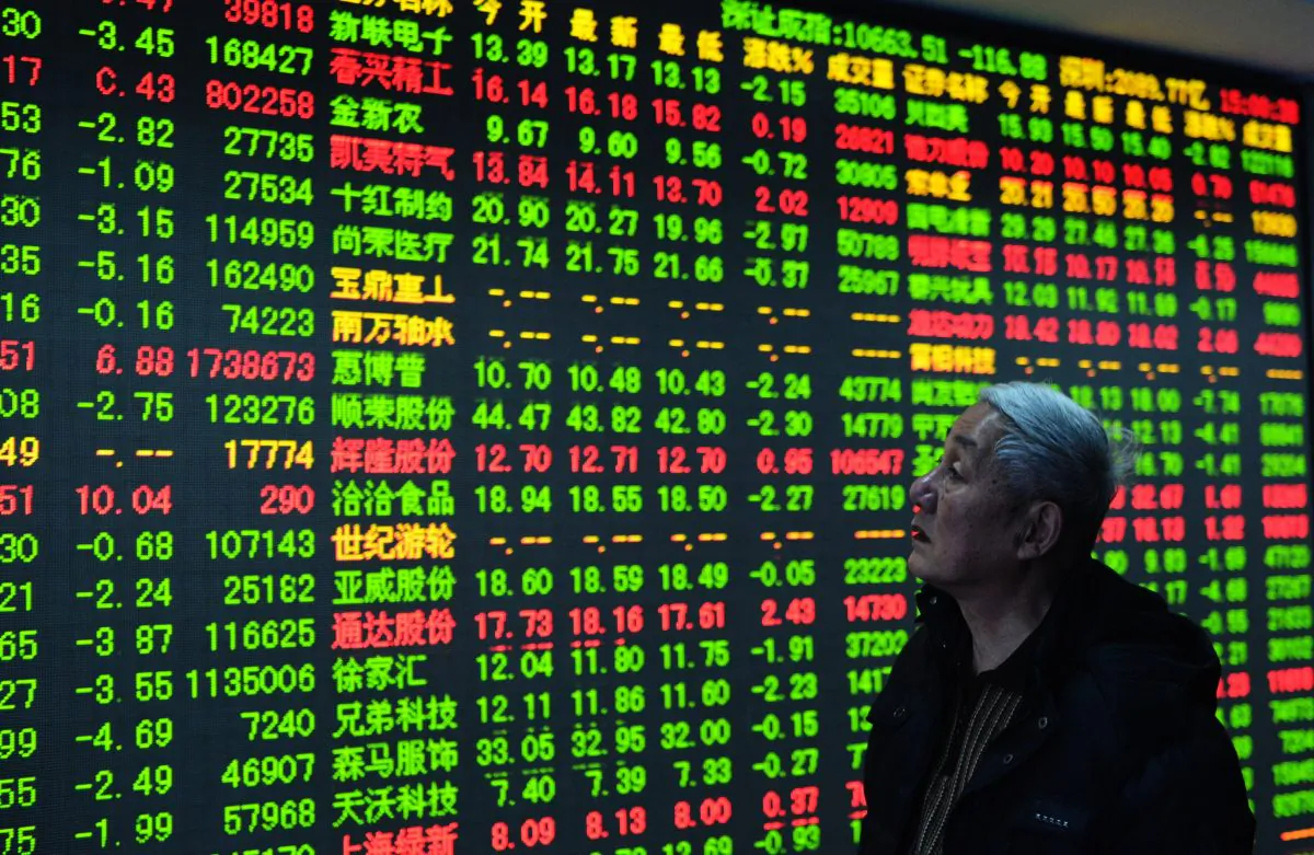 A trader checks share prices at a security firm in Hangzhou, east China's Zhejiang province, on Dec. 30, 2014. China's stock rally will likely see intense turbulence in the near future.
(STR/AFP/Getty Images)