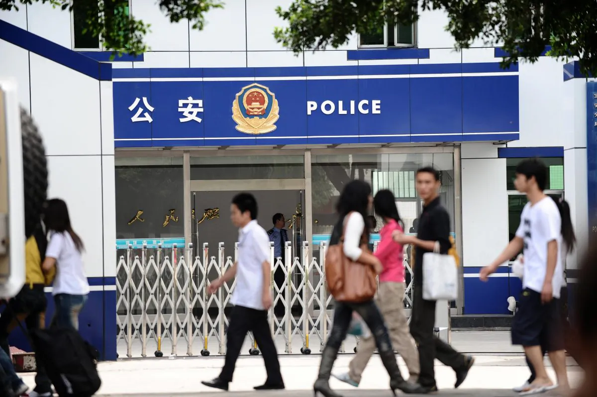Pedestrians walk past the police station in Shenzhen on November 8, 2008. Cases of communist officials murdering their mistresses have also been frequently reported in China. (AFP/AFP/Getty Images)