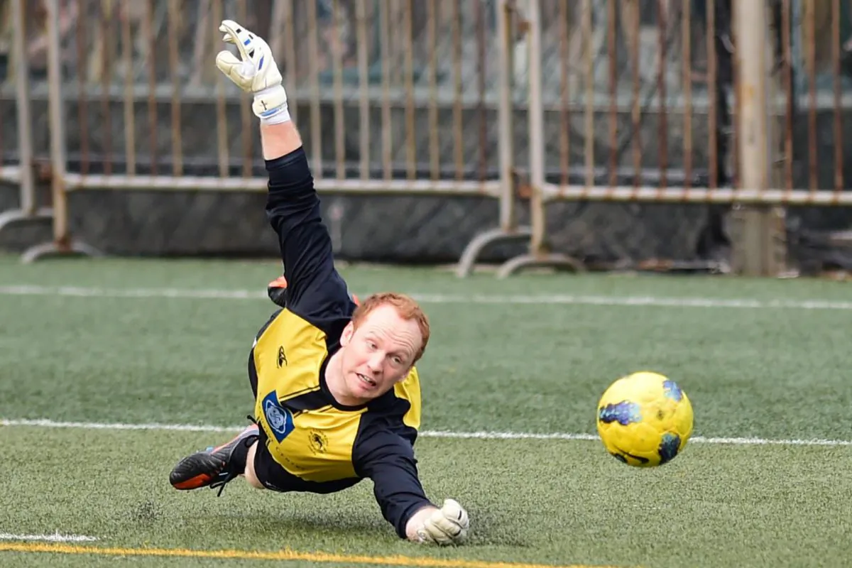 Colts goalkeeper Freddie Toomer just gets enough on this shot to push it wide of the far post, in a recent YYL division one game at Sports road. (Bill Cox/Epoch Times)