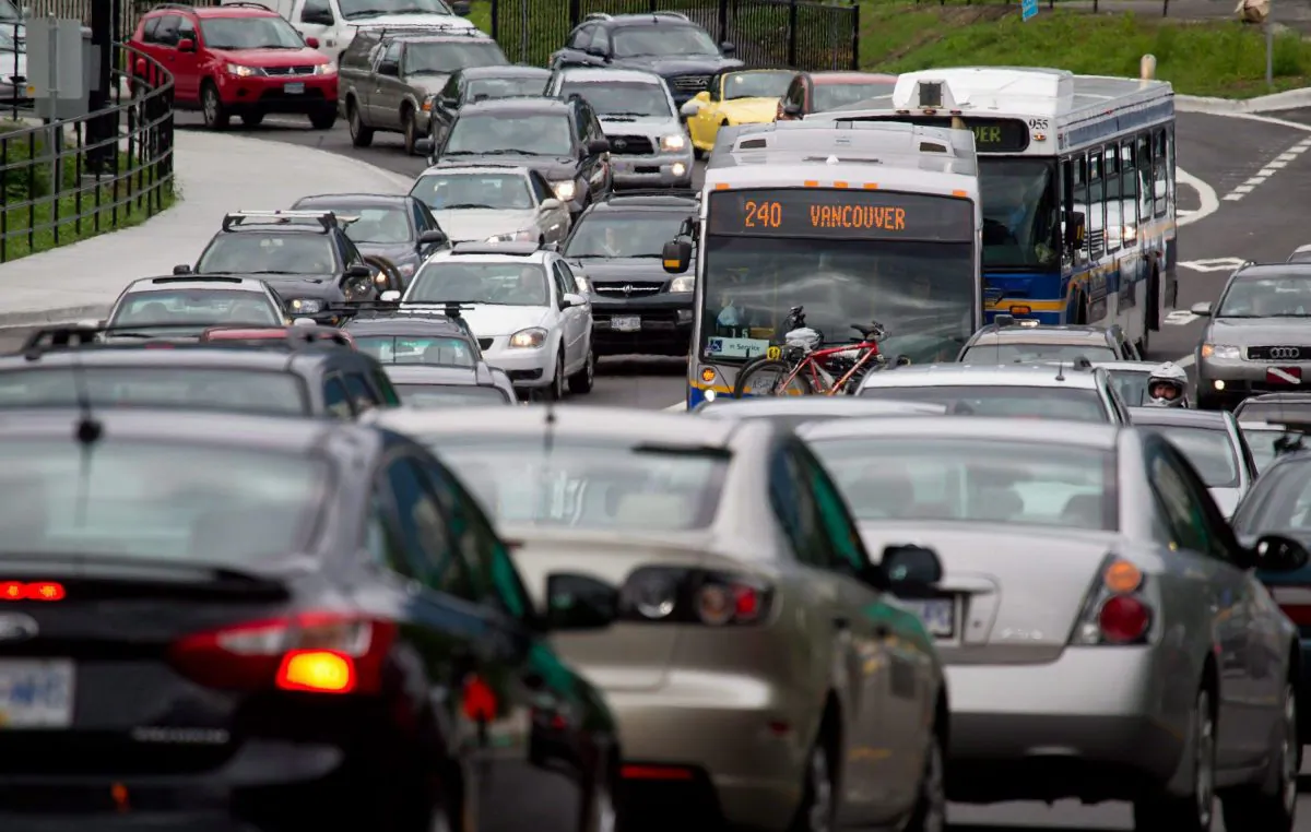 Motorists merge from four lanes into one as they enter the Lions Gate Bridge to drive into Vancouver on July 15, 2011. According to a traffic index compiled by TomTom, a firm that specializes in navigation and mapping products, the average commuter lost 84 hours in 2014 while delayed in traffic in Toronto, Vancouver, and Montreal. (The Canadian Press/Darryl Dyck)
