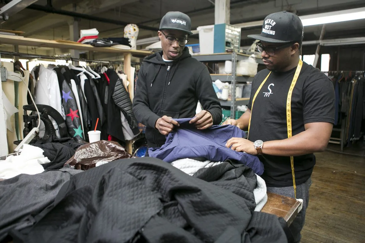 Clinton Ballard (L) and John Oliver, co-founders of Brooklyn Alchemist Station, at their clothing factory in Brooklyn on March 1, 2015. Their startup makes it easier for small designers to manufacture products in the U.S. (Samira Bouaou/Epoch Times)