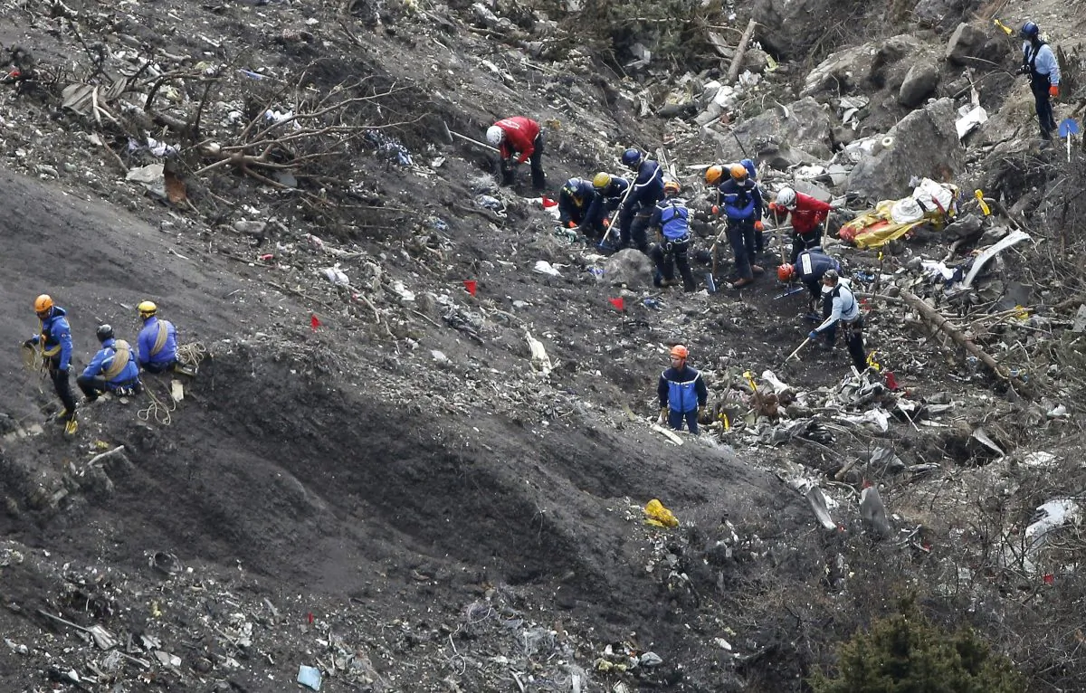 Rescue workers work at debris of the Germanwings jet at the crash site near Seyne-les-Alpes, France. Investigators recovering remains from all 150 people aboard a German passenger jet that crashed into the Alps have accelerated their timeframe for identifying and matching their DNA _ whether that be from a body part or only a shred of skin. (AP/Laurent Cipriani)
