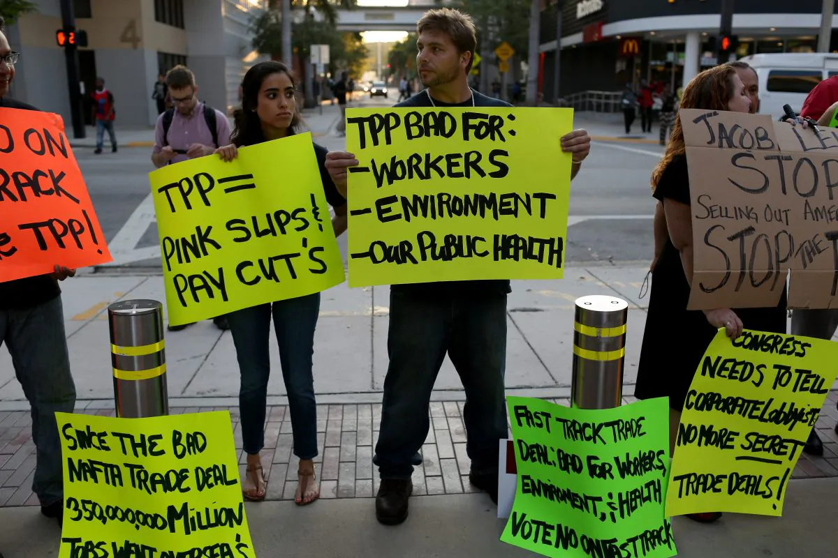 Protesters against the TPP, outside Miami Dade College, where the Greater Miami Chamber of Commerce and the college were hosting a moderated conversation with U.S. Secretary of the Treasury Jacob Lew on March 20, 2015. (Joe Raedle/Getty Images)