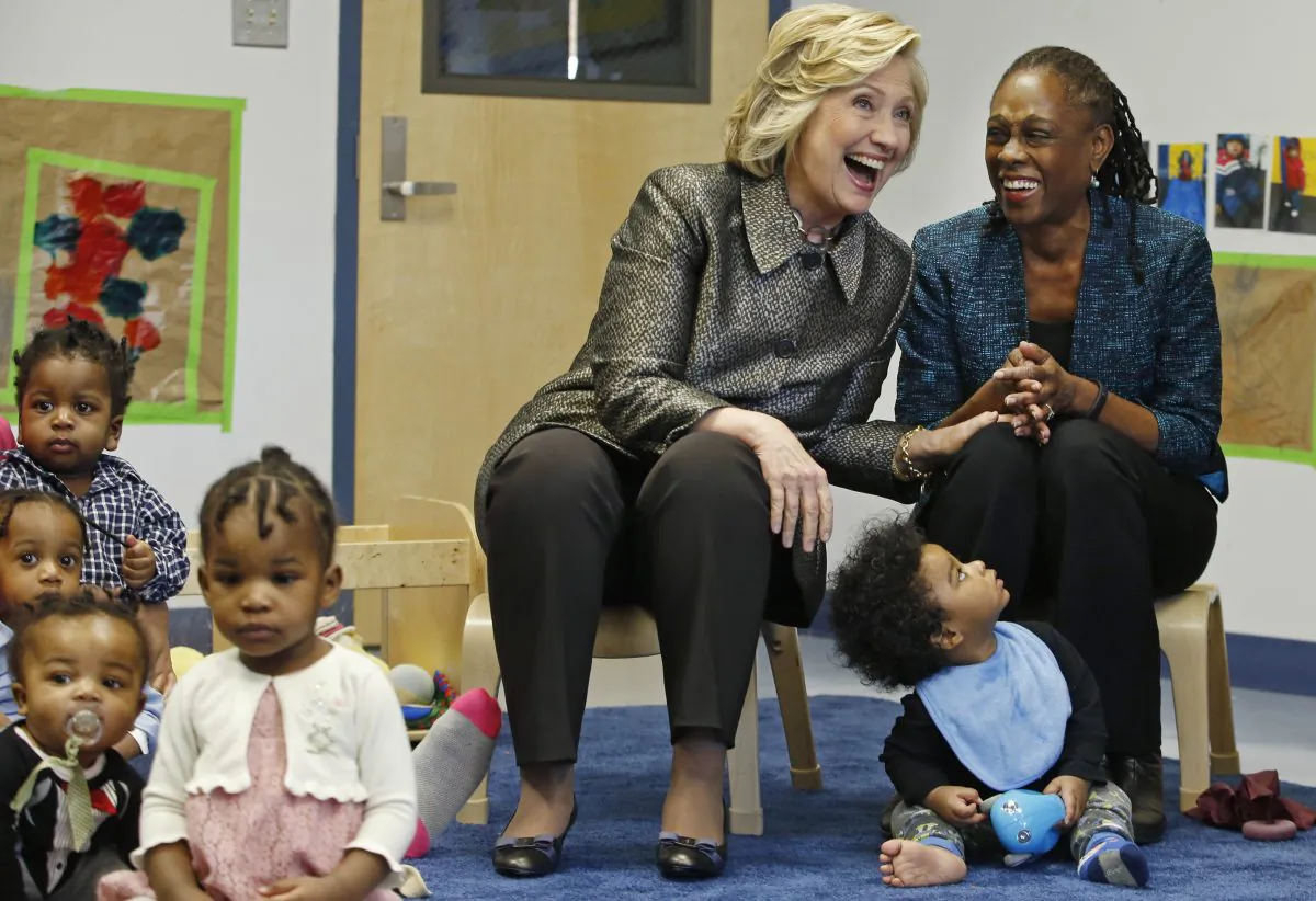 Former Secretary of State Hillary Rodham Clinton, center left, and New York City first lady Chirlane McCray, right, share a laugh during a visit to an early childhood development center in Brooklyn, New York City, Wednesday, April 1, 2015. Clinton and McCray are teaming up with New York's deputy mayor to launch a program encouraging parents to talk to their children, as a way to help with early childhood development. (AP Photo/Kathy Willens, Pool)