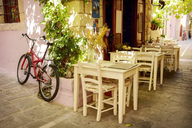 Street cafe in Greek town via Shutterstock*