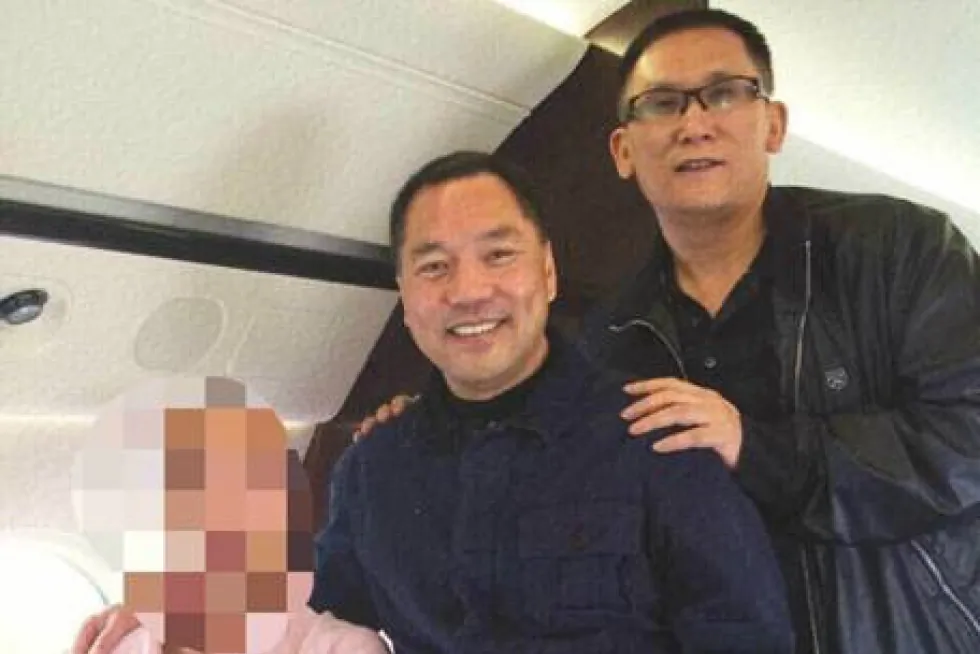 An undated photo posted on a Chinese microblog on March 23, 2015, shows Beijing Zenith’s Guo Wengui (left) and Founder Group’s Li You on a private jet. (Weibo) 