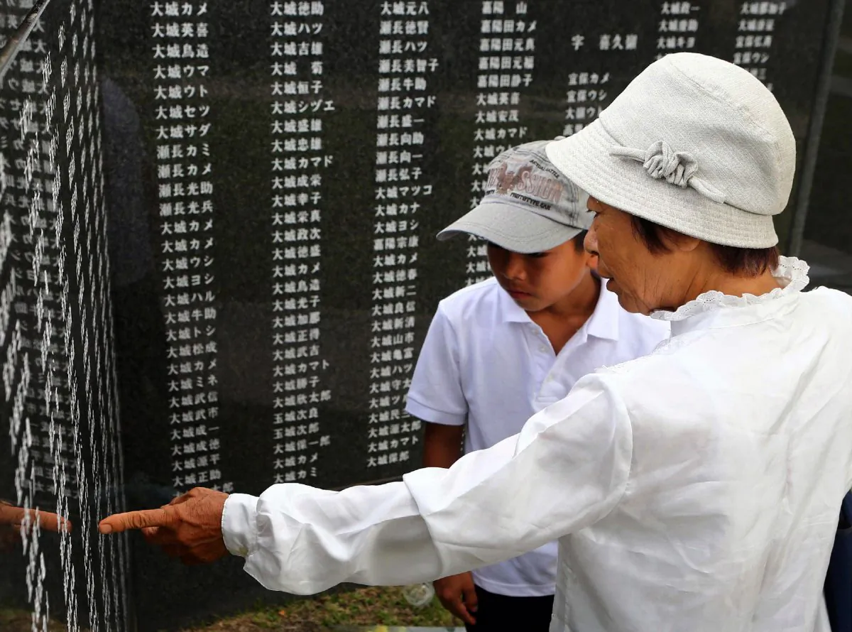 Relatives look at names on a Battle of Okinawa stone monument at Peace Memorial Park in Itoman on the island of Okinawa, Japan, on June 23, 2014. (JIJI PRESS/AFP/Getty Images)