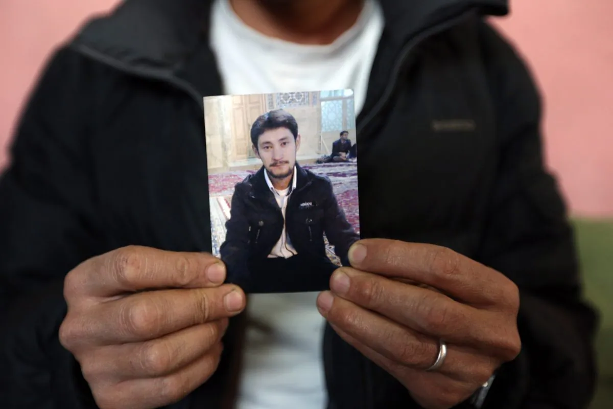 Mohammad Zahir, a Hazara man abducted in February, holds a photograph of his brother during an interview with The Associated Press in Kabul, Afghanistan, Saturday, April, 4, 2015. (AP Photo/Rahmat Gul)