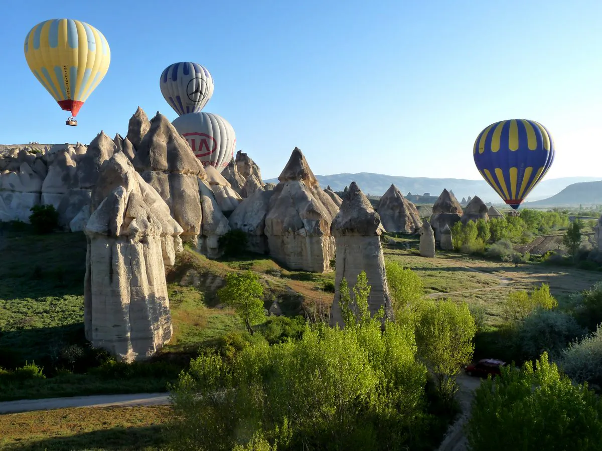 Hot air balloons glide over Cappadocia’s fairy chimney wonderland. Sedimentary rocks, formed from volcanic material millions of years ago, were eroded by the elements into minaret and pillar shapes, which became known as fairly chimneys. (Manos Angelakis)