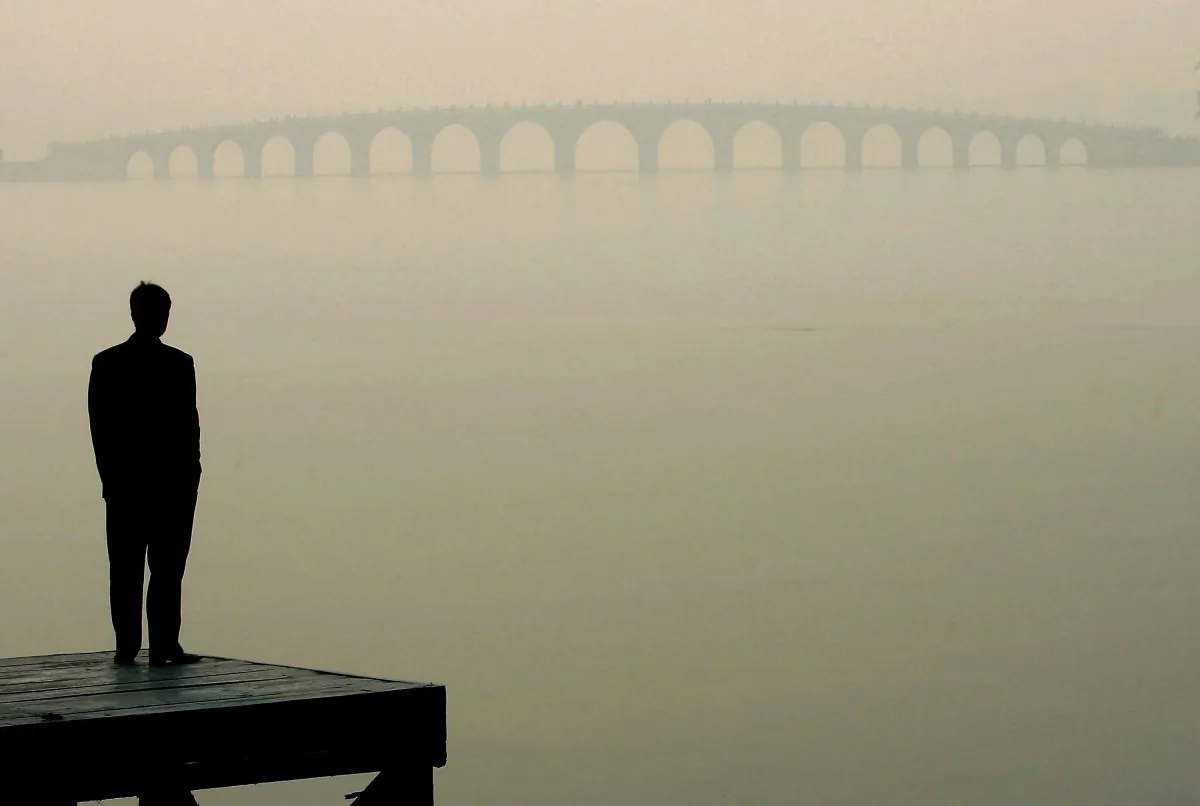 A man looks towards a bridge in heavy fog in Beijing in this file photo. (Guang Niu/Getty Images)
