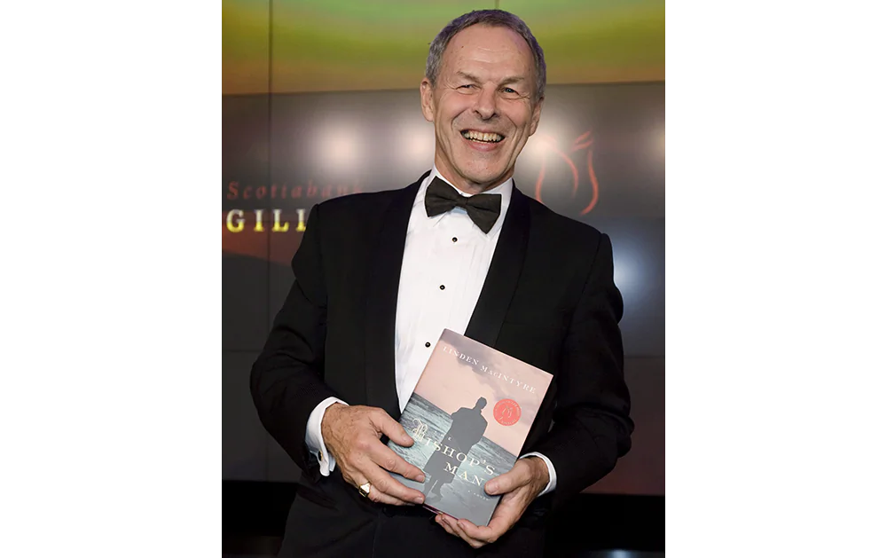 Author Linden MacIntyre poses with his novel “The Bishop’s Men” at the Giller Prize gala in 2009. MacIntyre, former host of the CBC’s “The Fifth Estate,” is one of three authors participating in the Crime and Punishment discussion during the Ottawa International Writers Festival. (The Canadian Press/Darren Calabrese)