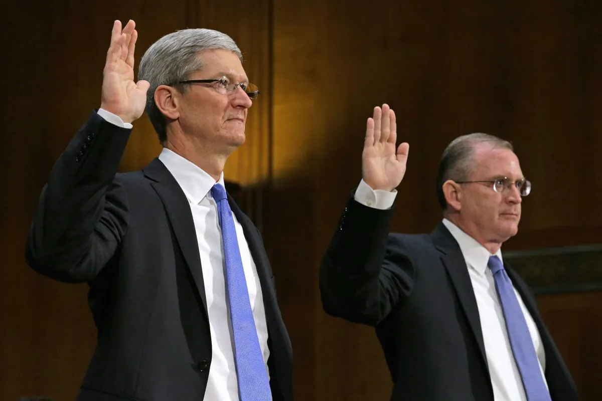 Apple CEO Timothy Cook (L) and Apple head of tax operations Phillip Bullock are sworn in before testifying to the Senate Homeland Security and Governmental Affairs Committee's Investigations Subcommittee about the company's offshore profit shifting and tax avoidance on Capitol Hill on May 21, 2013. (Chip Somodevilla/Getty Images)