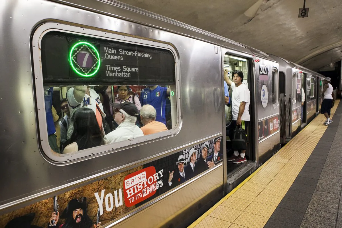 People wait on a 7 train that is being held at the Grand Central subway station on July 30, 2014.  (Samira Bouaou/Epoch Times)