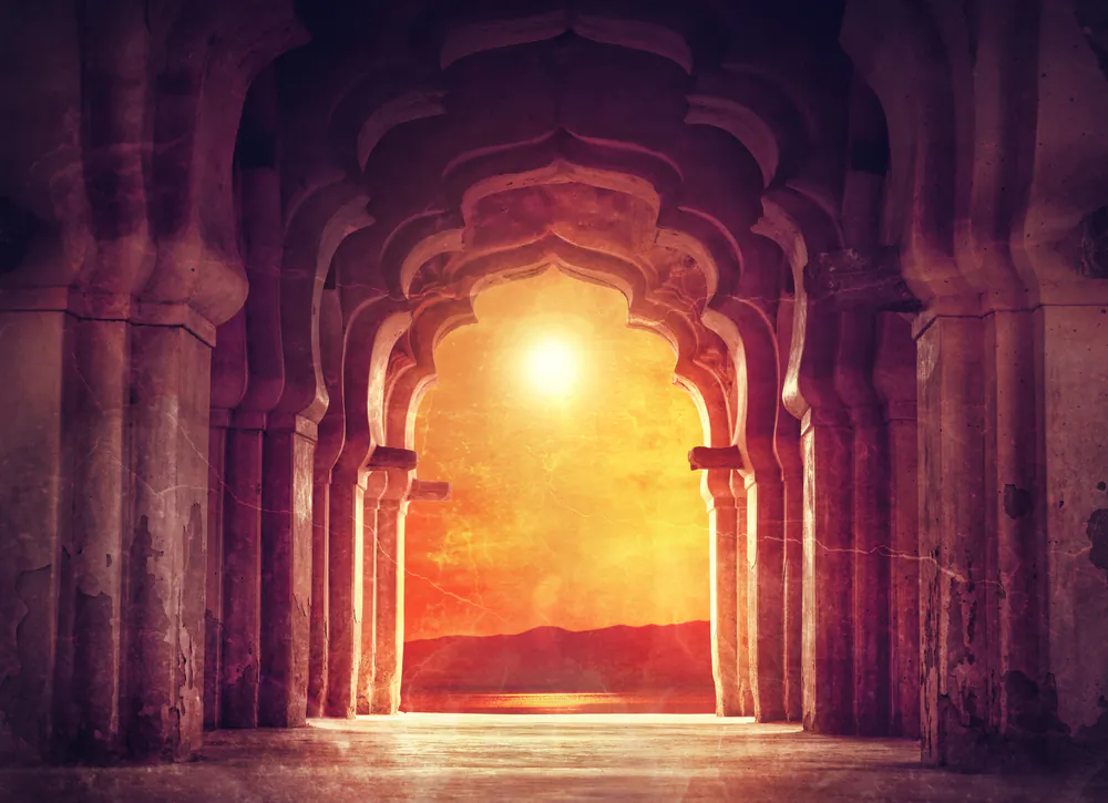 Old ruined arch in ancient temple at sunset in India via Shutterstock*