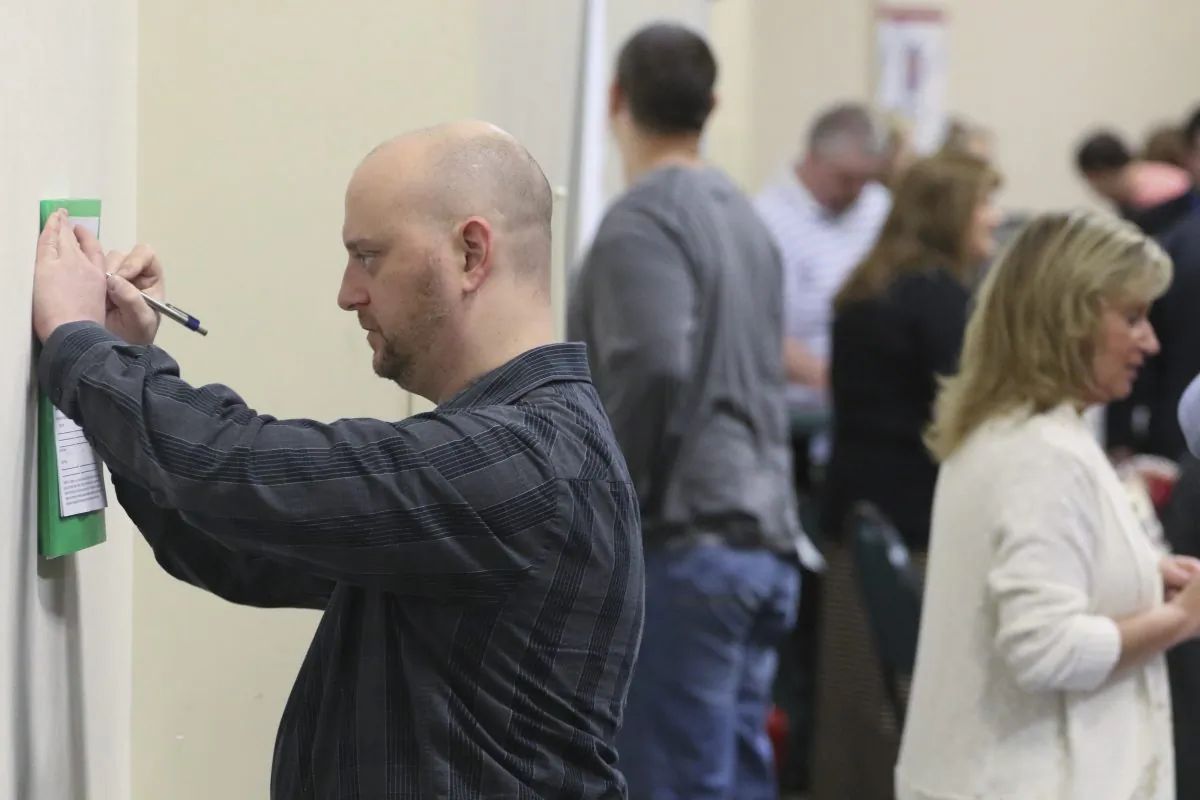 In this April 2, 2015 photo, Daniel Marquardt from LaFayette, Ga., fills out an application during a huge 15-county job fair in Ringgold, Ga. The Labor Department released weekly jobless claims on Thursday, April 9, 2015. (AP Photo/Chattanooga Times Free Press, Dan Henry)
