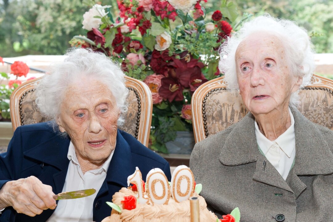 Marie Hendrix (L) and Gabrielle Vaudremer, 100-year-old Belgian twins celebrate their birthday. (Nicolas Lambert/AFP/Getty Images)