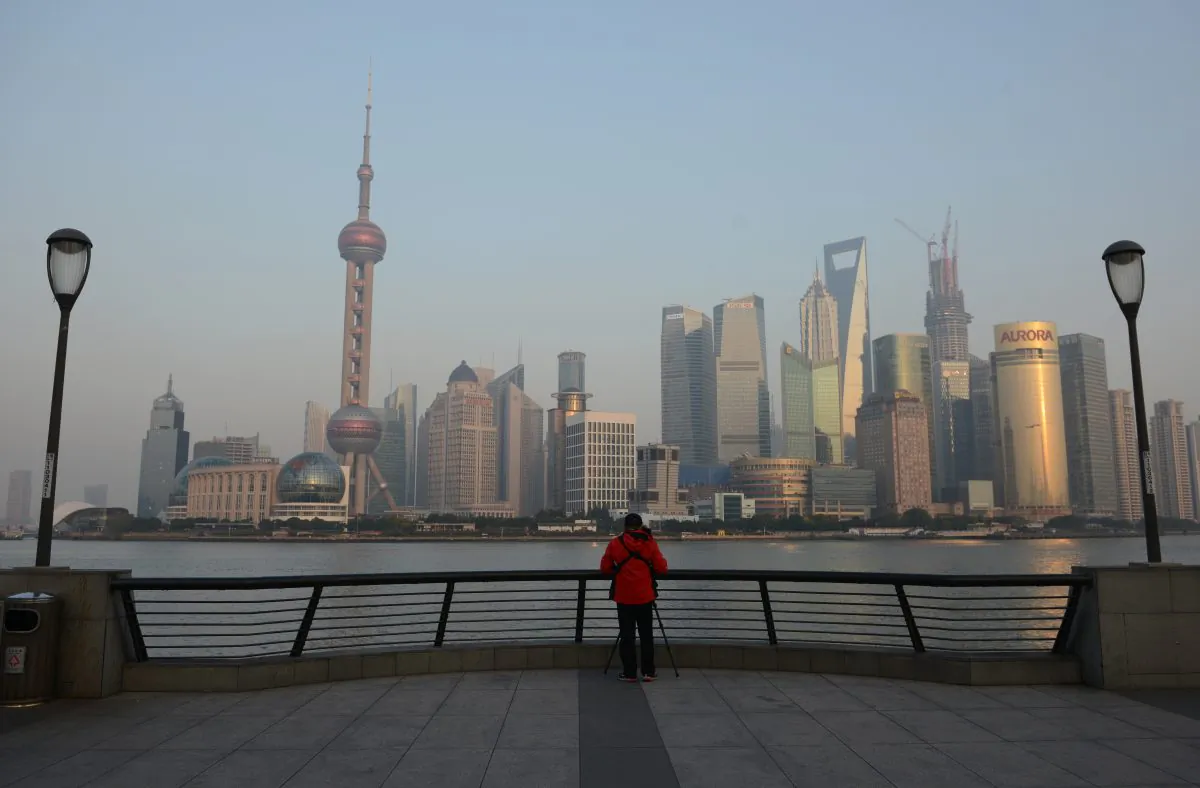 A photographer takes photos of the financial district of Pudong from the Bund in Shanghai on November 27, 2012. (Peter Parks/AFP/Getty Images)