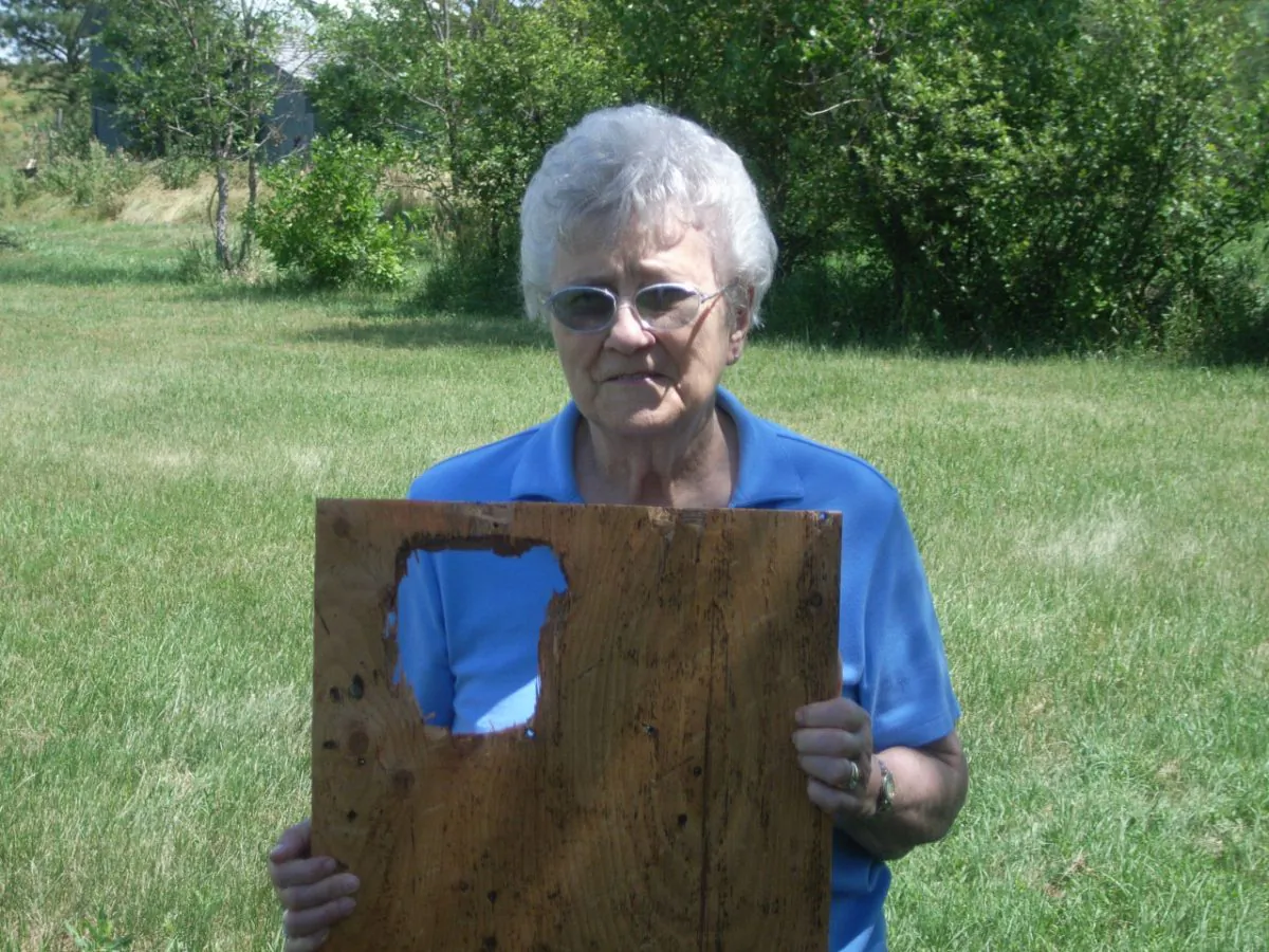 A resident of Vivian, SD displays a section of roof that was damaged by the hailstorm on July 23, 2010. (Courtesy of NOAA)
