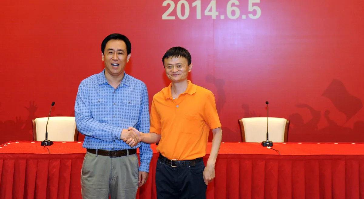 Founder and chairman of Alibaba Group Jack Ma (R) shakes hands with Chairman of Evergrande Group Xu Jiayin during a signing ceremony between Alibaba Group and Evergrande Group regarding Alibaba buying 50 percent of shares in Guangzhou Evergrande on June 5, 2014 in Guangzhou, Guangdong Province of China. (ChinaFotoPress/ChinaFotoPress via Getty Images)
