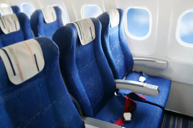 Seat rows in an airplane cabin via Shutterstock*