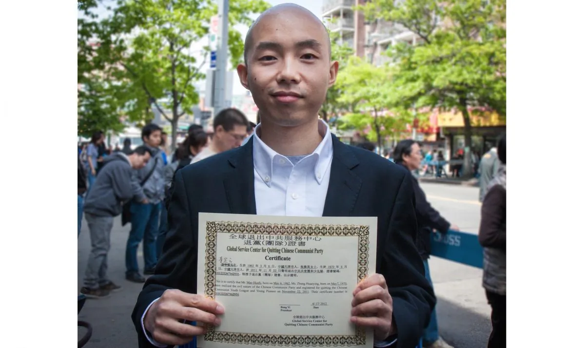 A Chinese man hold his certificate of withdrawal from the Chinese Communist Party (CCP), declaring the renounciation of his ties to the CCP at a rally in Flushing, New York City, on April 28, 2012. (Benjamin Chasteen/Epoch Times)