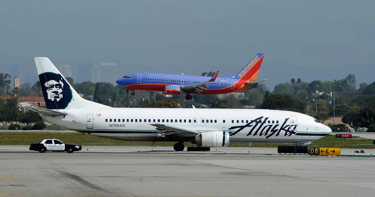 A Southwest Airlines Boeing 737 passanger jet lands as an Alaska Air Boeing 737 jet prepares to take off at Los Angeles International Airport in Los Angeles on April 5, 2011. (Kevork Djansezian/Getty Images)